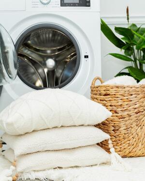 clean clothes stacked outside of laundry