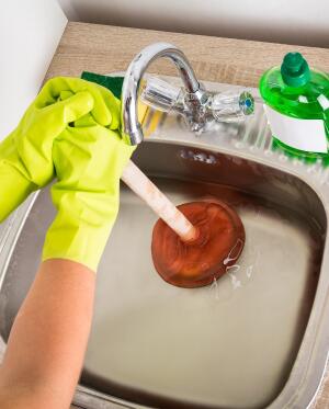 person plunging sink