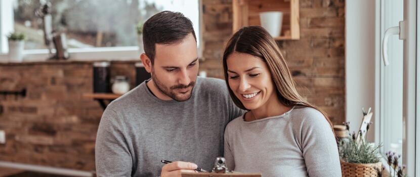 couple looks at documents together in home